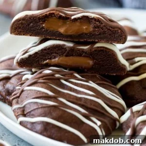 A serving plate of decadent Nutella cookies, with one cookie cut in half to reveal its gooey center.