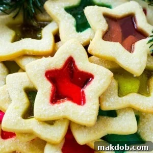 These beautiful stained glass cookies are buttery sugar cookies with a colorful, translucent candy center.