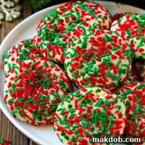 A plate of colorful cake mix cookies rolled in vibrant sprinkles, ready for any celebration.