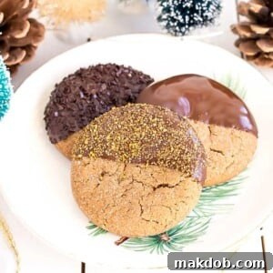 Rich chocolate-dipped gingerbread cookies, a perfect blend of spicy and sweet for the festive season.