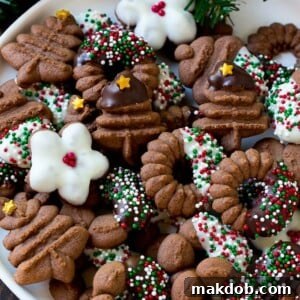 A plate of charming chocolate spritz cookies, elegantly decorated with chocolate drizzle and sprinkles.