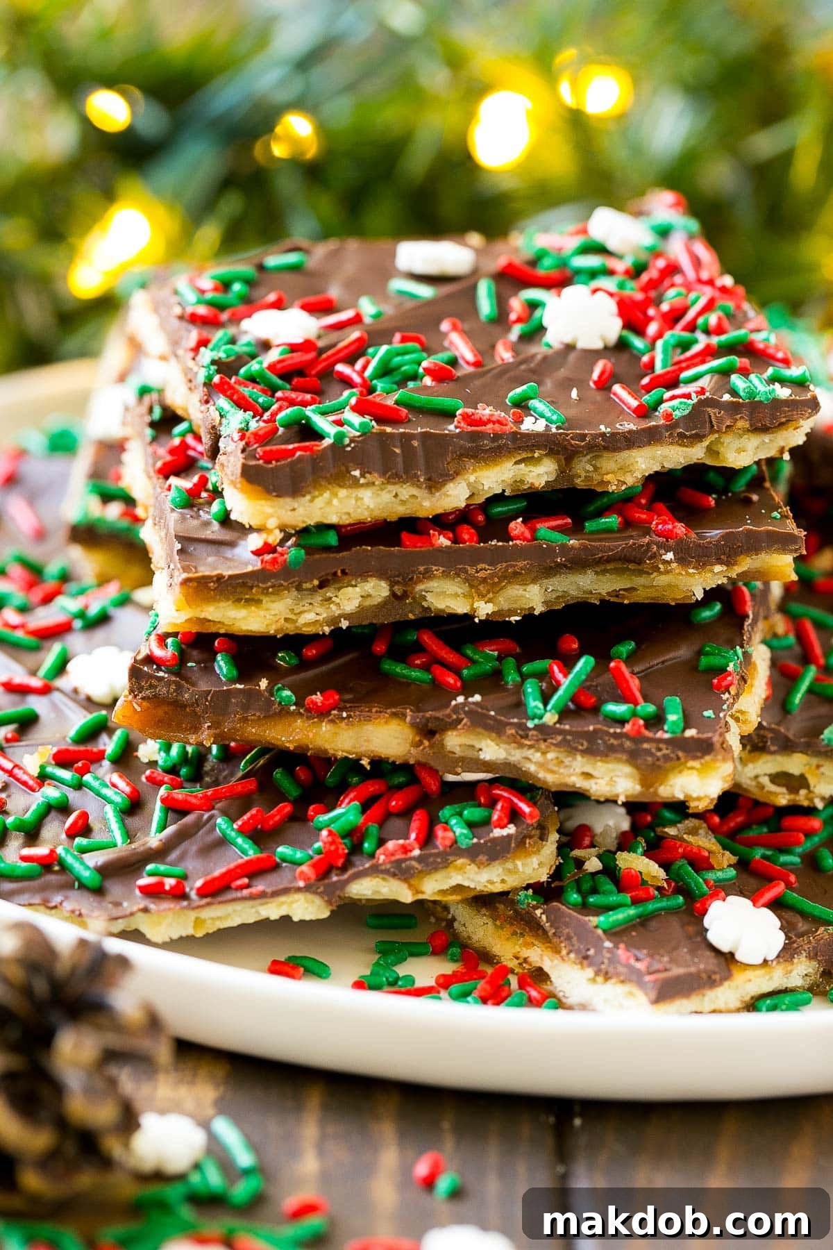 Irresistible Holiday Toffee Bark 2 A festive platter showcasing an abundance of Christmas crack, generously sprinkled with holiday decorations, ready to be enjoyed.
