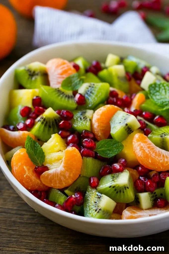 This winter fruit salad is made with oranges, kiwi, pineapple and pomegranates.