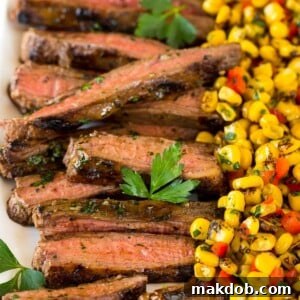 Sliced grilled flank steak on a platter.