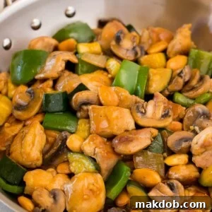 A pan of almond chicken stir fry with vegetables.