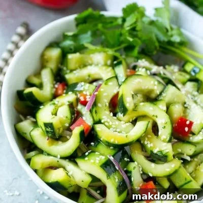 This recipe for Asian cucumber salad is cucumbers and colorful veggies tossed in a zesty sesame dressing. The perfect quick and easy side dish!