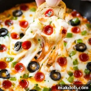 Pizza dip loaded with all your favorite pizza toppings, baked to golden and gooey perfection and served with baguette slices.