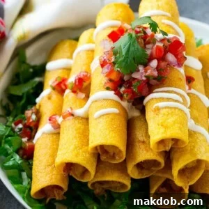 A stack of chicken taquitos with a drizzle of sour cream and pico de gallo topping.