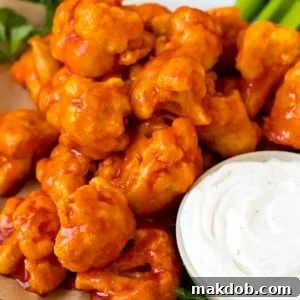 Buffalo cauliflower bites served with ranch and celery.