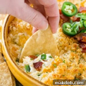 This jalapeno popper dip is creamy, cheesy, spicy, loaded with bacon and totally addicting! Serve it with tortilla chips for the ultimate party snack.