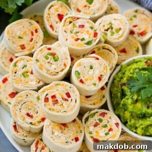 Taco pinwheels made with cream cheese, chicken, cheddar cheese and bell peppers.