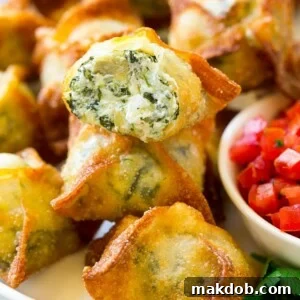 Spinach artichoke wontons with homemade spinach artichoke dip stuffed into wonton wrappers and fried to golden perfection.