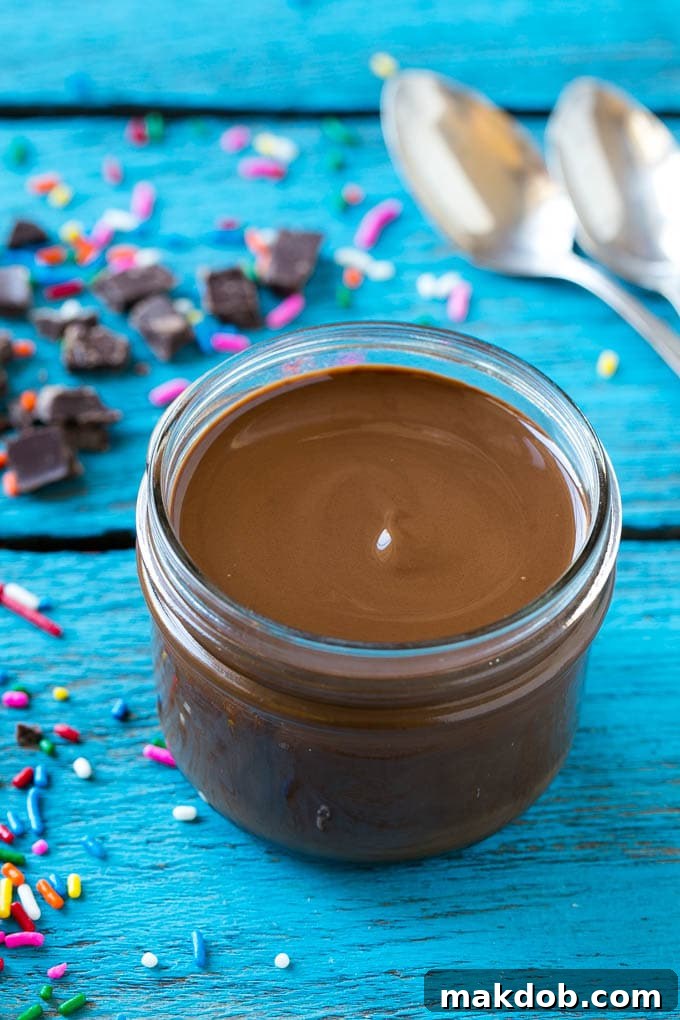 Homemade Magic Shell Recipe | Chocolate Ice Cream Topping | Chocolate Sauce | Hard Chocolate Coating #chocolate #icecream #dessert #dinneratthezoo A jar of chocolate chocolate shell.