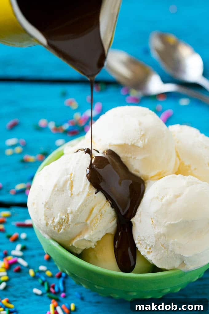 Homemade Magic Shell Recipe | Chocolate Ice Cream Topping | Chocolate Sauce | Hard Chocolate Coating #chocolate #icecream #dessert #dinneratthezoo A pitcher of chocolate sauce being poured over vanilla ice cream.