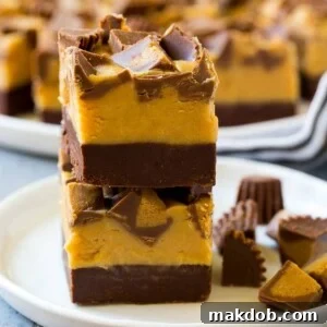 A tempting display of stacked chocolate peanut butter fudge squares on a plate, showcasing a rich, layered confection perfect for sharing or gifting.