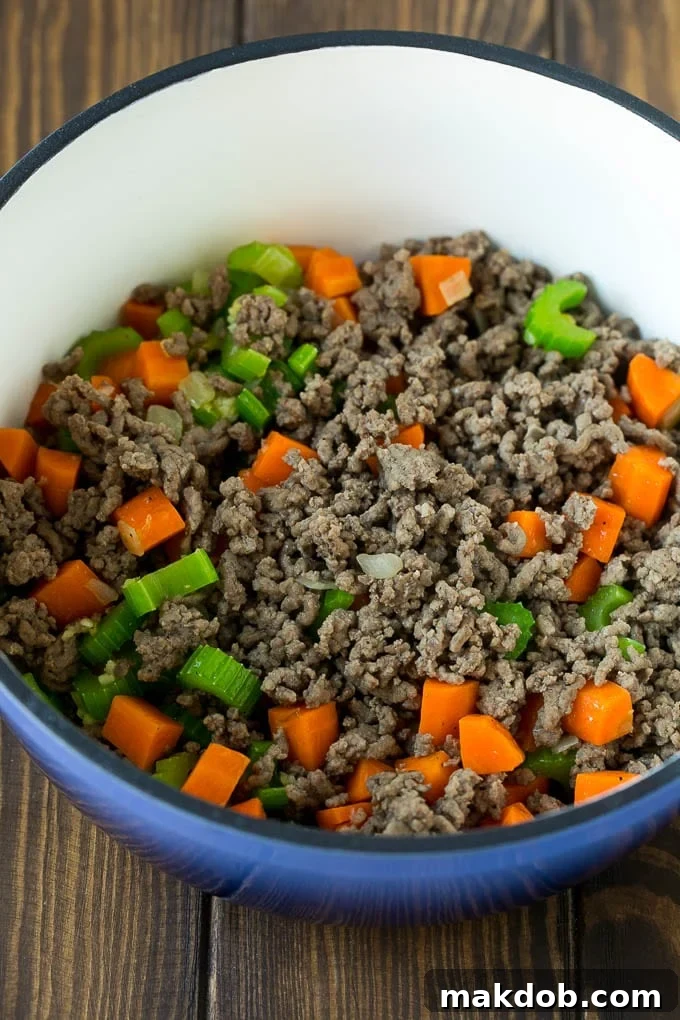 Ground beef, carrots, onion and celery in a soup pot.
