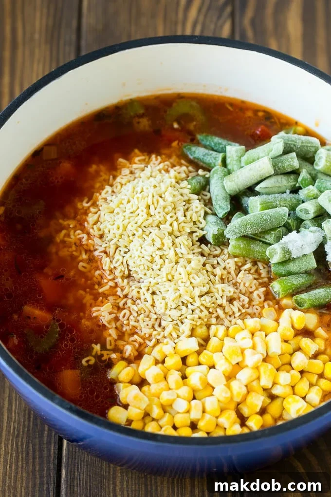 Alphabet Soup Recipe | Hamburger Soup | Beef and Vegetable Soup #soup #hamburger #noodles #dinner #dinneratthezoo #carrots A pot with alphabet noodles, rich broth, frozen corn and frozen green beans simmering together.