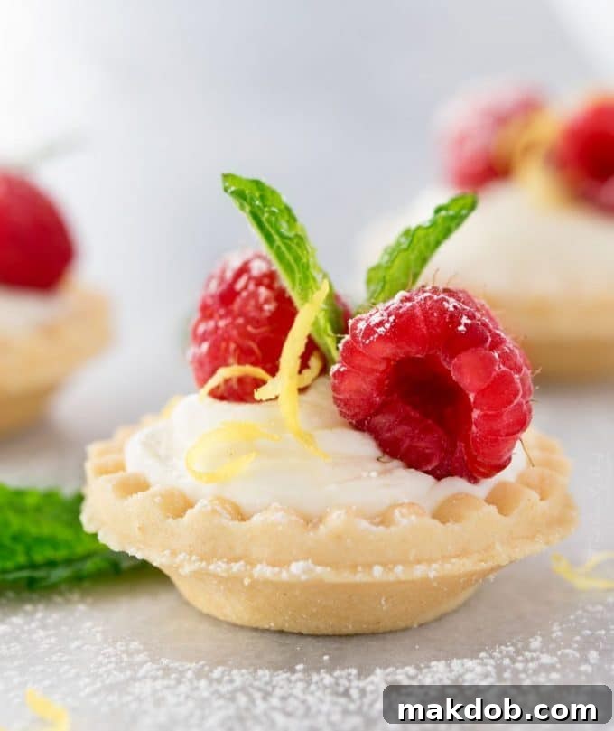 Mini no-bake white chocolate lemon cheesecake tarts, refreshing and creamy with a zesty lemon kick.