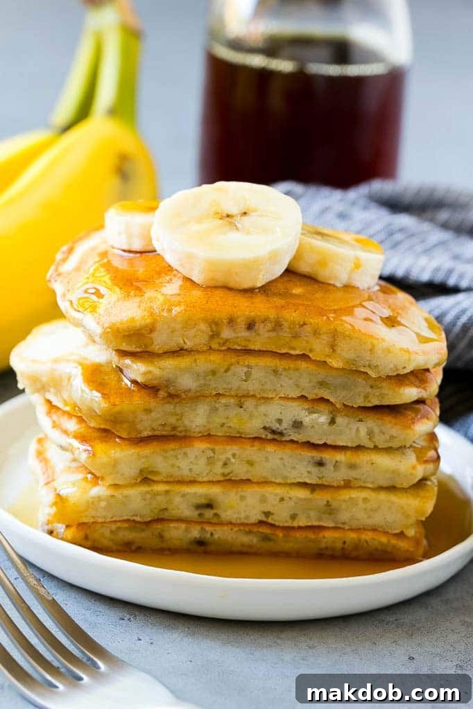 Cross-Section of Fluffy Banana Pancakes A cross section revealing the fluffy interior of a stack of banana pancakes, highlighting their soft texture.