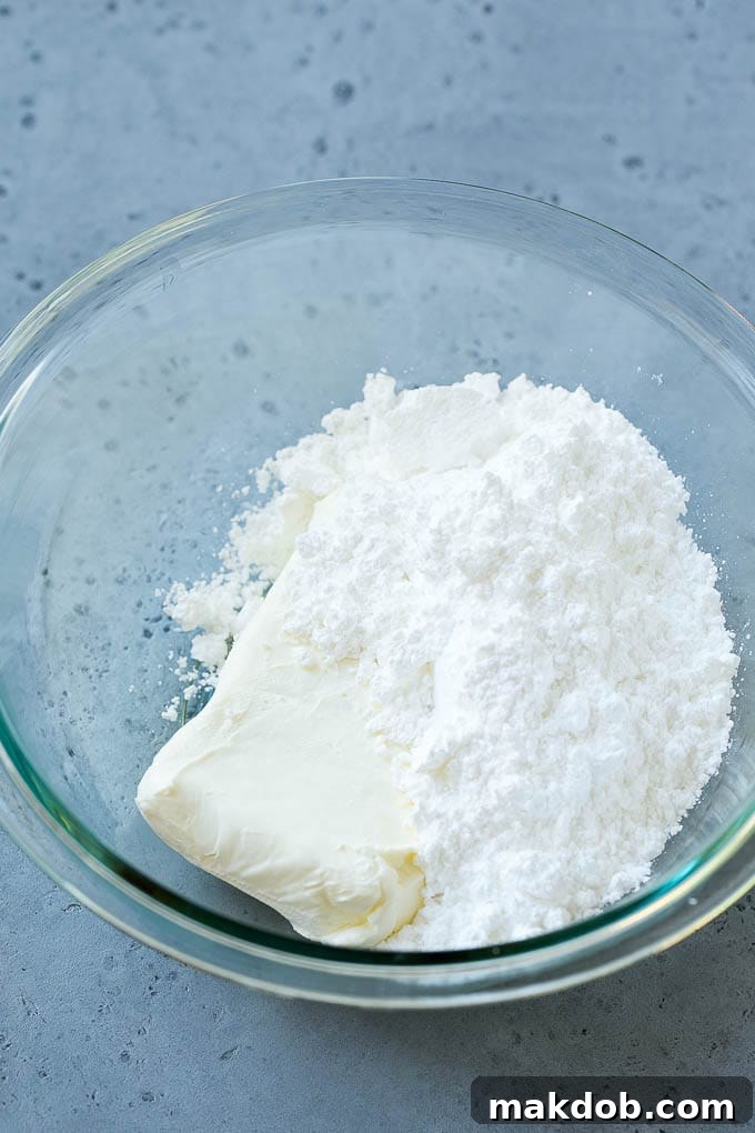 Powdered sugar and cream cheese in a bowl.