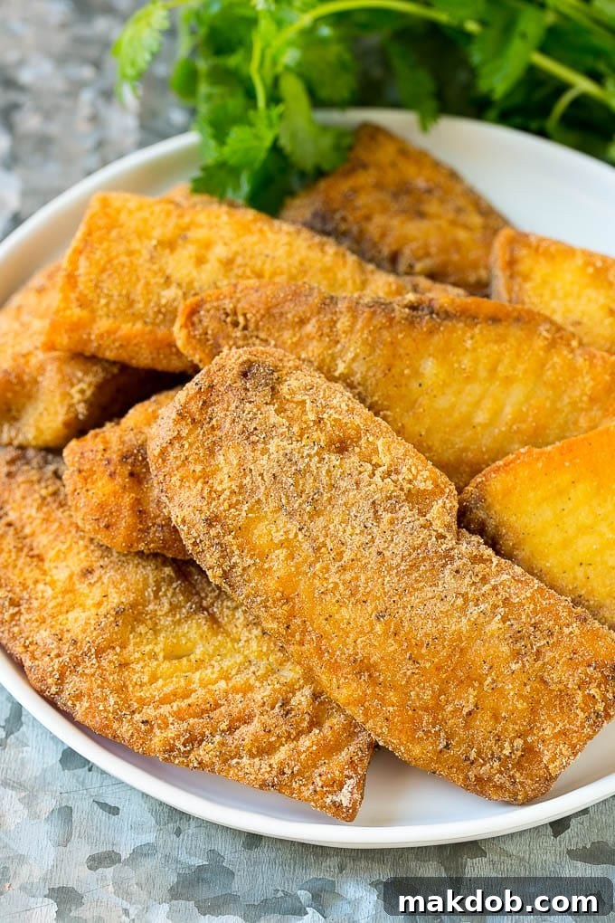 Fried and breaded fish fillets on a serving plate, ready to be assembled into delicious Baja fish tacos.