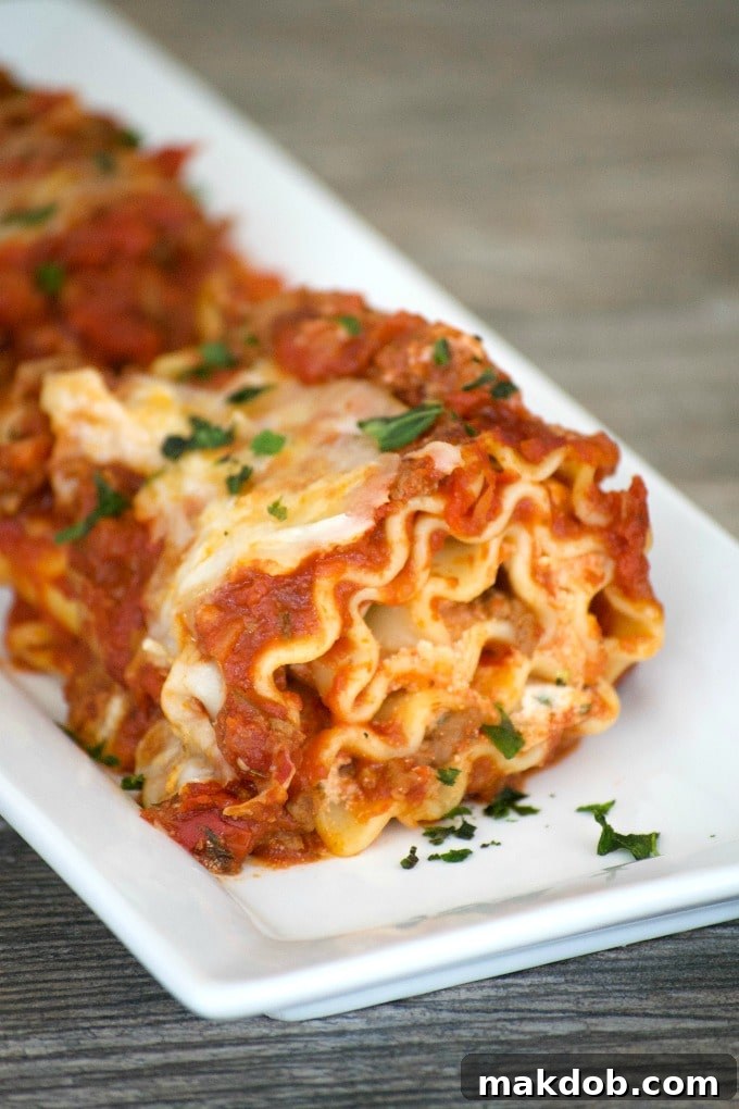Hearty Lasagna Rolls with meat sauce and melted cheese, garnished with fresh parsley.