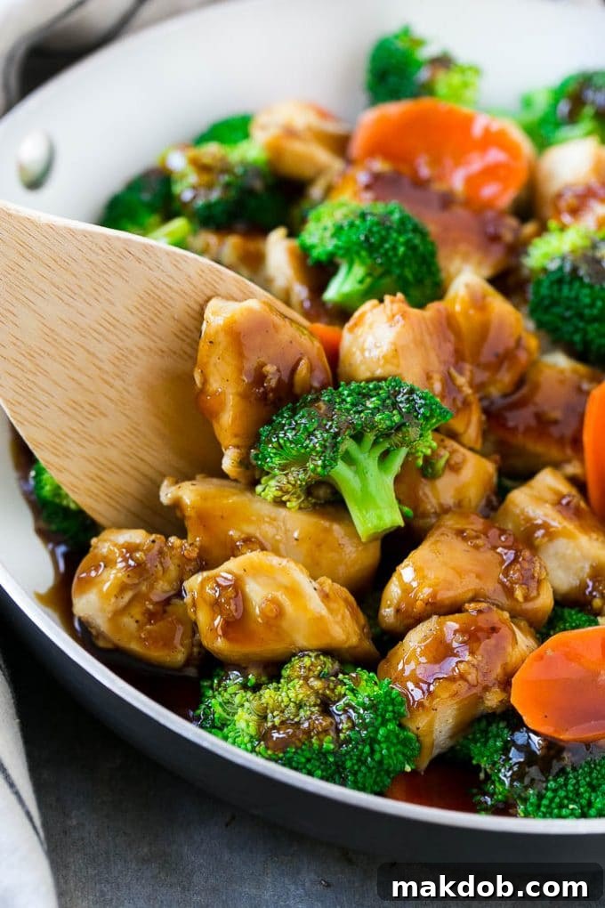 Honey Garlic Chicken Stir Fry with chicken, broccoli, carrots, and bell peppers, coated in a sweet and savory sauce.