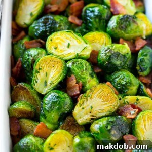 A dish of bacon roasted brussels sprouts with parsley.