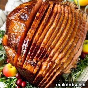 A ham covered in homemade ham glaze, garnished with fruit.