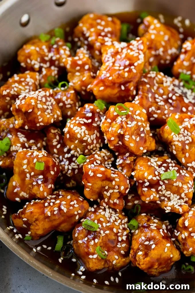 Sesame Chicken Recipe | Crispy Chicken | Asian Chicken #sesame #chicken #asian #dinner #dinneratthezoo Crispy sesame chicken in a pan, coated in a sweet and savory sauce and sesame seeds. A close-up view highlighting the golden crisp and glistening sauce.