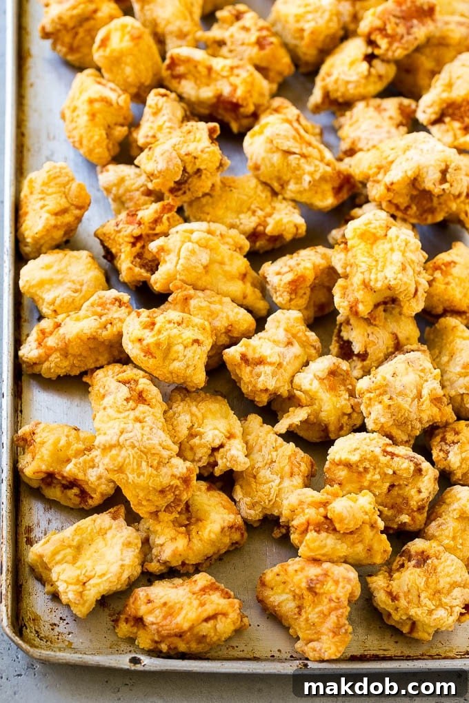 Sesame Chicken Recipe | Crispy Chicken | Asian Chicken #sesame #chicken #asian #dinner #dinneratthezoo Fried chicken breast pieces on a sheet pan, golden brown and crispy.