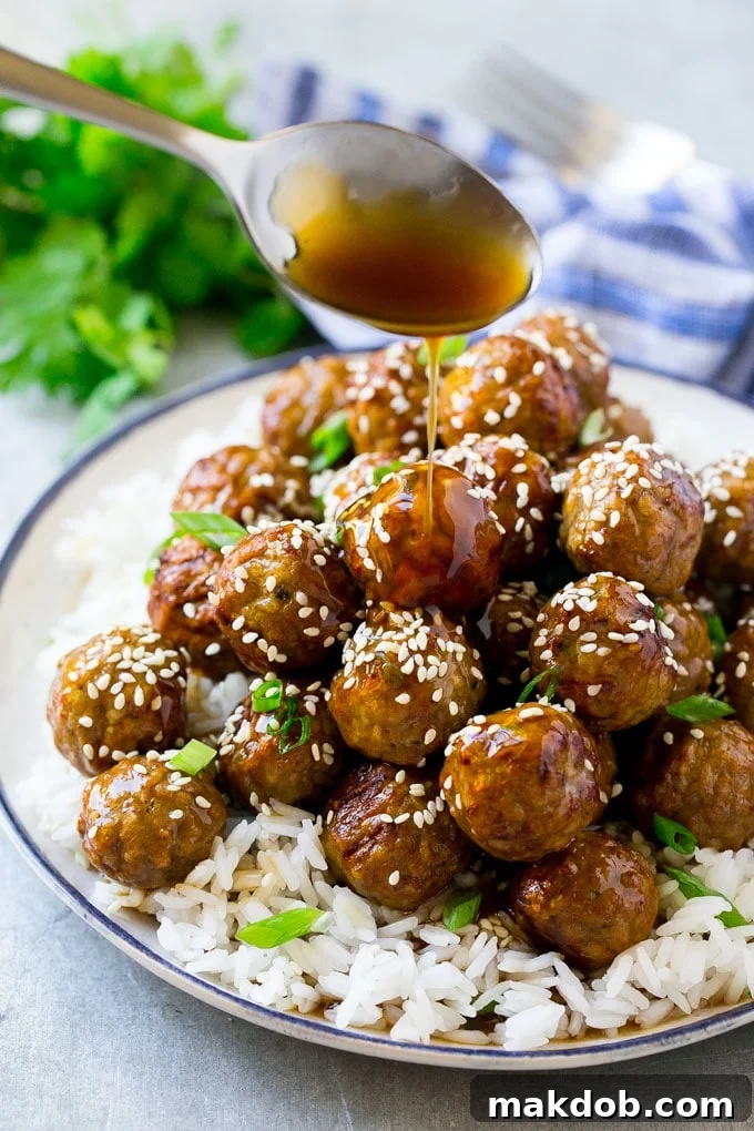 Homemade Teriyaki Meatballs Recipe: A Flavorful & Quick Dinner Solution A close-up of a generous serving of teriyaki meatballs, perfectly coated in a rich, glossy sauce, nestled on a bed of rice and garnished for a vibrant presentation.