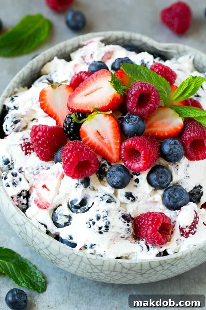 Berry cheesecake salad with fresh mixed berries tossed in a creamy dressing.