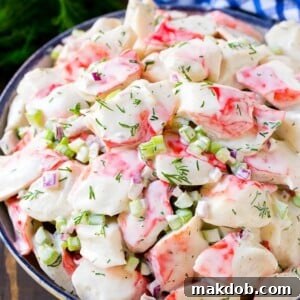 Creamy crab salad with fresh vegetables and dill in a mayonnaise dressing.