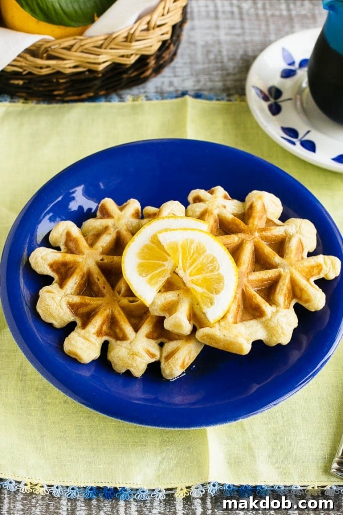 Zesty Lemon Sour Cream Waffles 4 A perfectly cooked lemon sour cream waffle cooling on a wire rack, ready for toppings. Learn how to achieve the ideal golden-brown crispness for your homemade waffles.