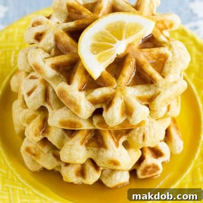 This recipe for lemon waffles made with sour cream are light and fluffy with the perfect amount of tang. Serve these waffles with maple syrup or lemon curd for the perfect weekend breakfast!