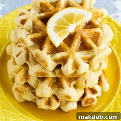 This recipe for lemon waffles made with sour cream are light and fluffy with the perfect amount of tang. Serve these waffles with maple syrup or lemon curd for the perfect weekend breakfast!