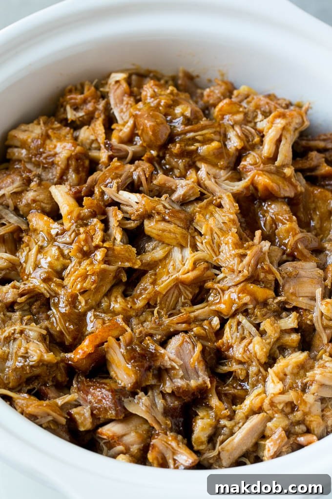 Prepping Pork for Slow Cooker: Seasoned Chunks in a Crockpot for Tender Pulled Pork. #pork #slowcooker #crockpot #mealprep A slow cooker filled with seasoned pork chunks, ready to be cooked.