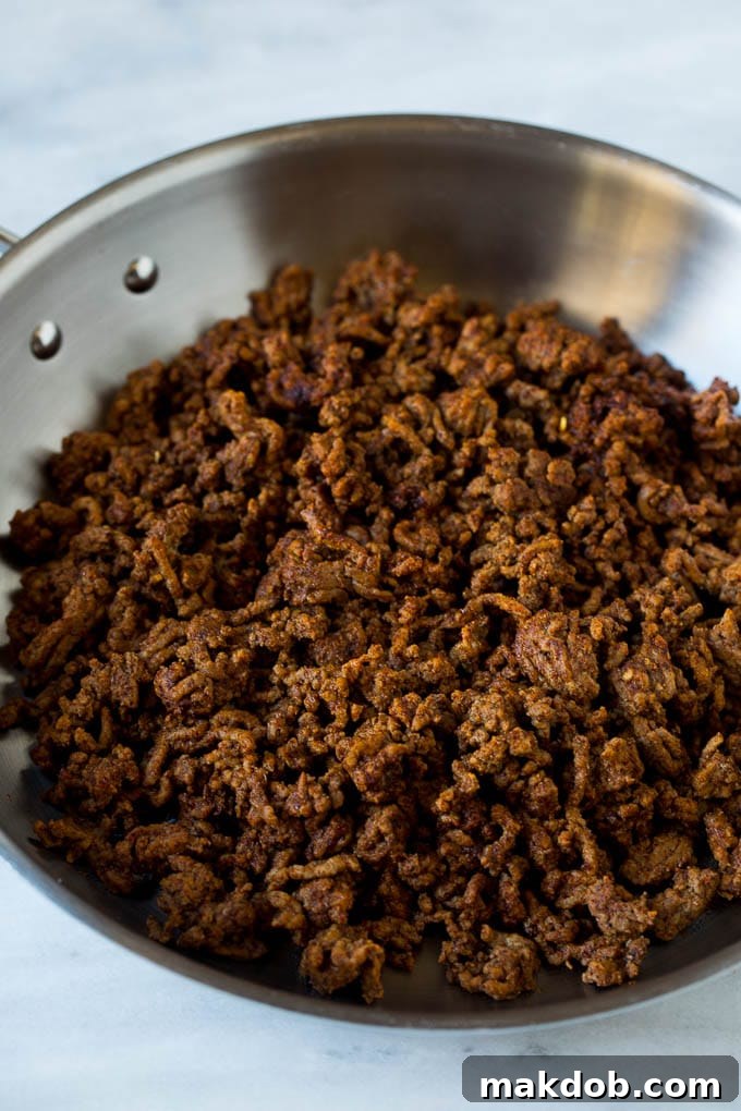 Mexican Pizza Recipe #mexicanfood #beef #dinneratthezoo Taco meat in a skillet.