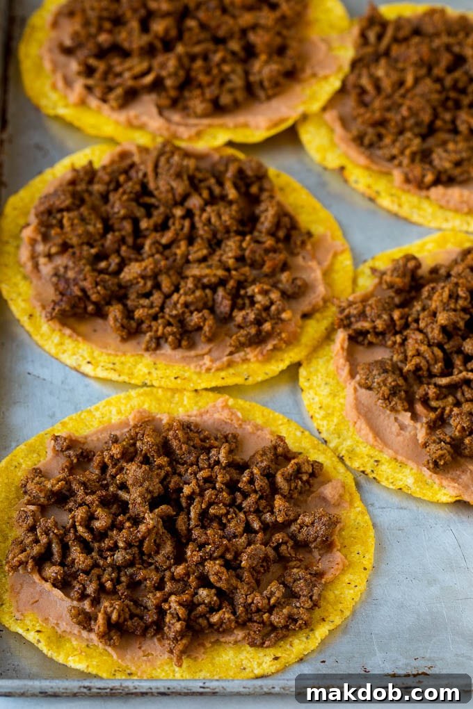Mexican Pizza Recipe #mexicanfood #beef #dinneratthezoo Tostada shells topped with refried beans and taco meat.