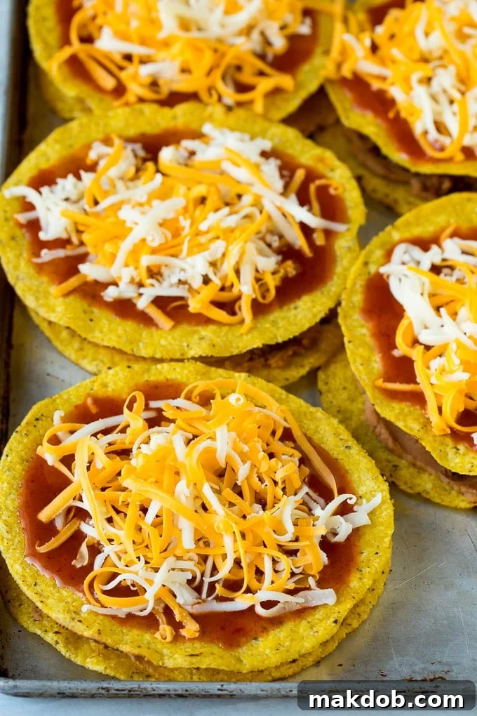Mexican Pizza Recipe #mexicanfood #beef #dinneratthezoo Layered tostadas topped with enchilada sauce and shredded cheese.