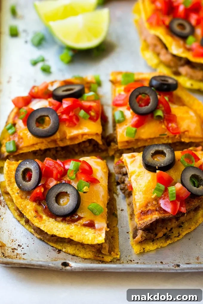 Mexican Pizza Recipe #mexicanfood #beef #dinneratthezoo A Mexican pizza cut into 4 slices.