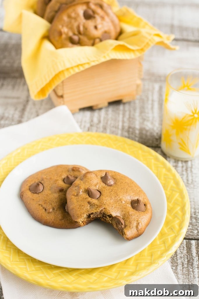 Seriously Gooey Flourless Chocolate Cookies 4 Freshly baked flourless chocolate chip cookies cooling on a wire rack, showcasing their golden edges and soft centers.