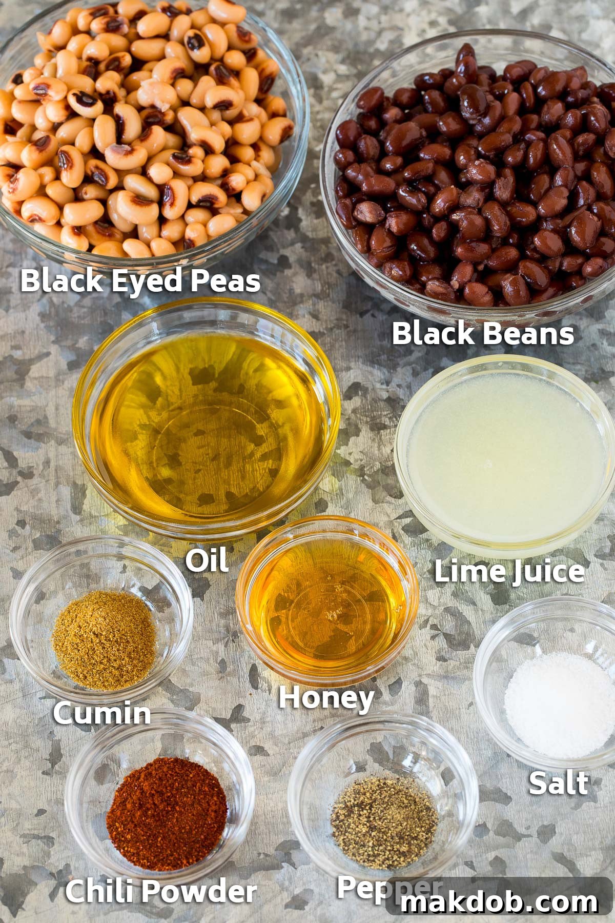 Fiesta Bean Salad 4 Bowls of beans, black eyed peas and salad dressing ingredients.
