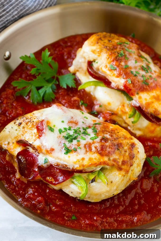 Pizza Stuffed Chicken Recipe | Stuffed Chicken Breast | Baked Chicken Breast | Easy Chicken Recipe #chicken #pizza #stuffedchicken #chickenbreast #dinner #dinneratthezoo Two generously stuffed chicken breasts, golden-brown from searing and covered in rich tomato sauce and bubbling cheese, ready for the oven.