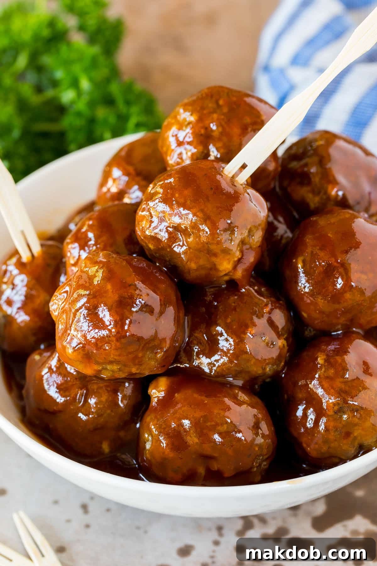Slow-Cooker BBQ Meatball Magic 6 A bowl of crockpot BBQ meatballs with toothpicks in them.