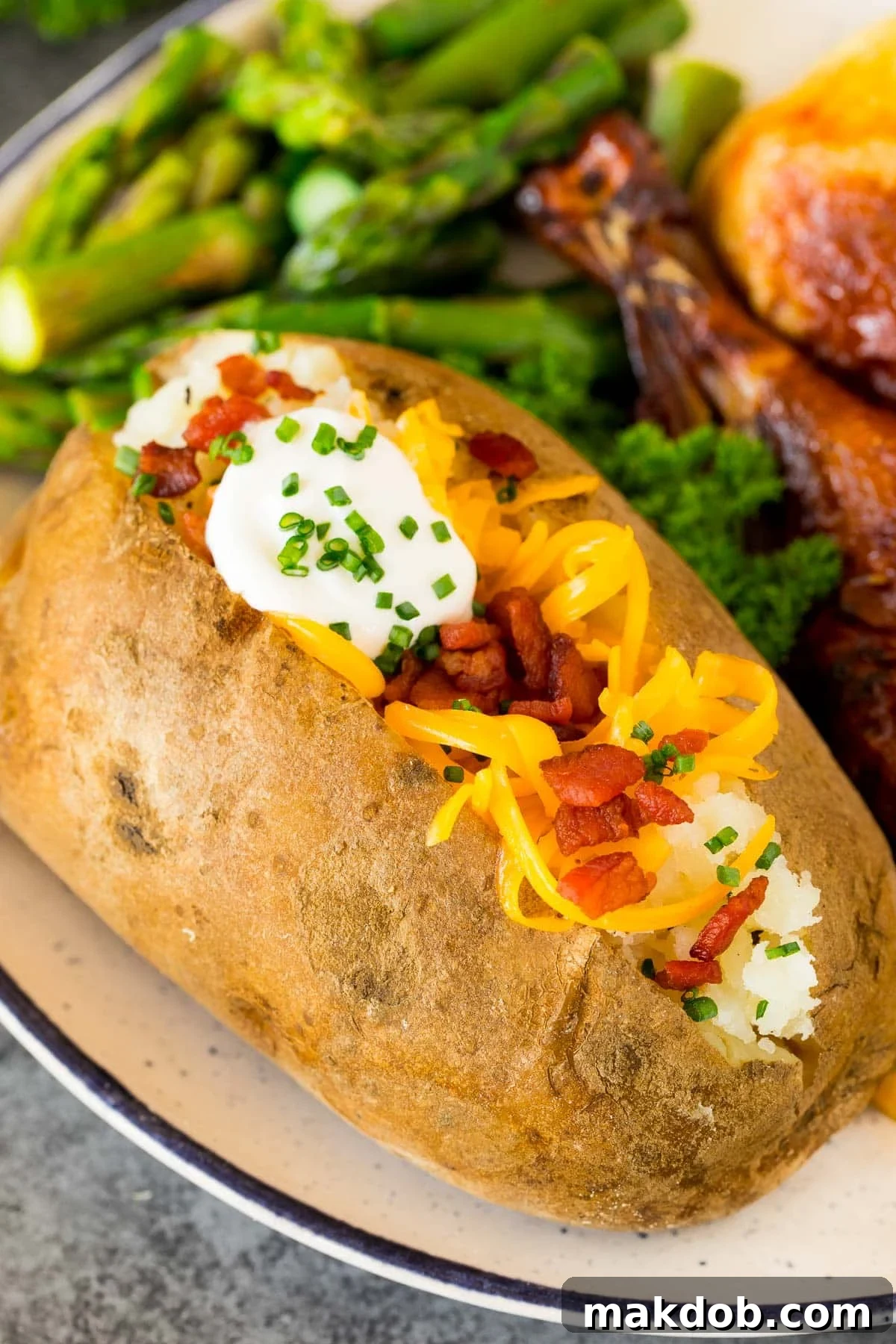 Instant Pot baked potatoes topped with cheese, bacon and sour cream, showcasing their fluffy interior.