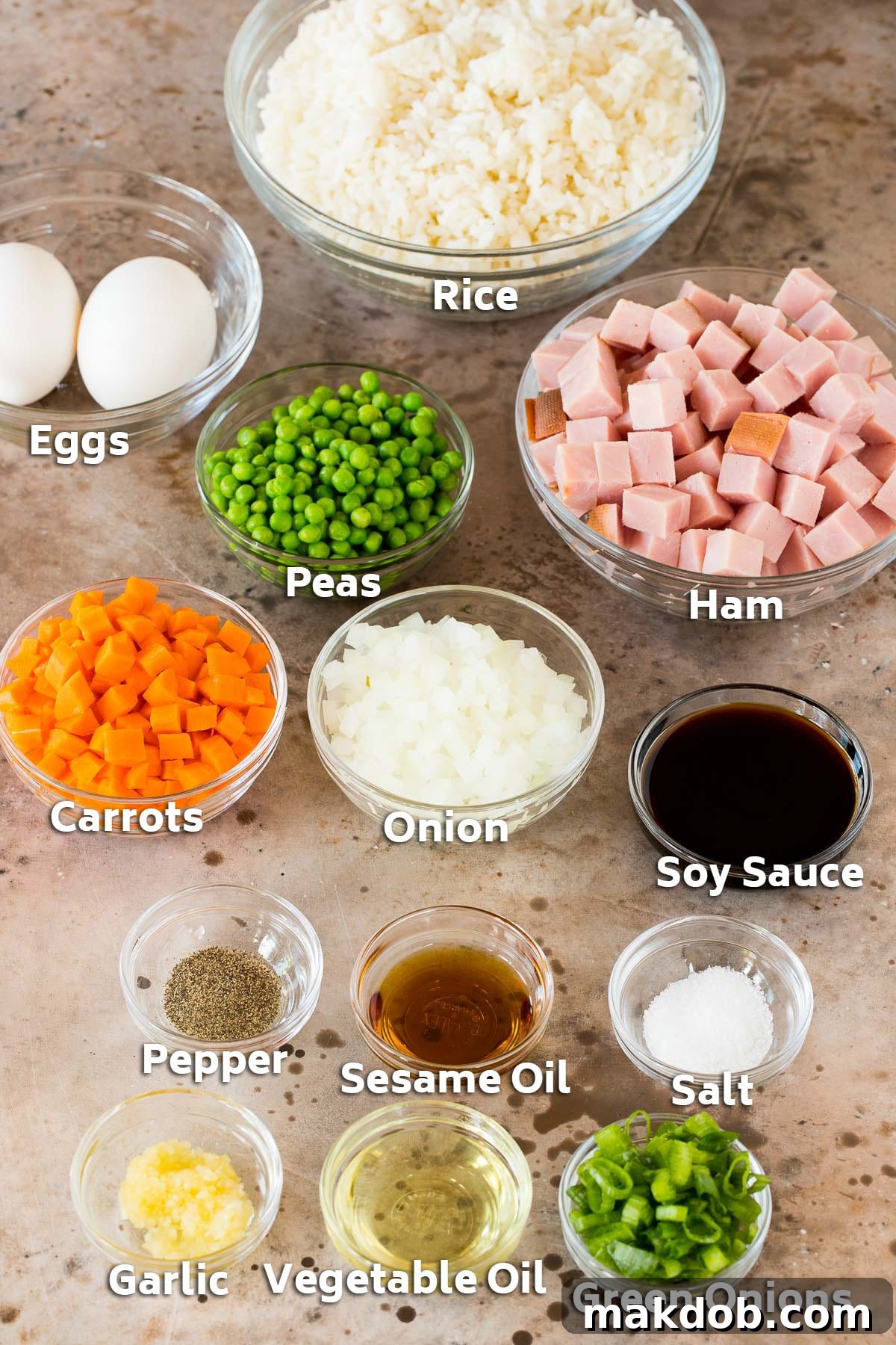 Bowls of ingredients including ham, rice, vegetables and seasonings.