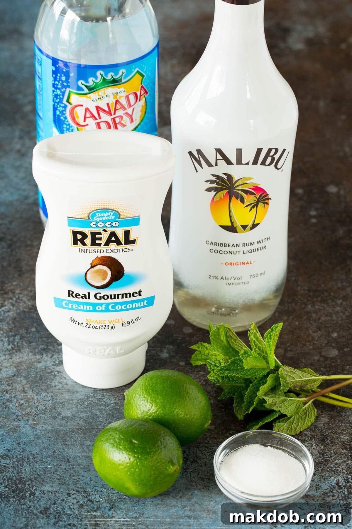 Ingredients including coconut rum, coconut cream, club soda, mint and limes.